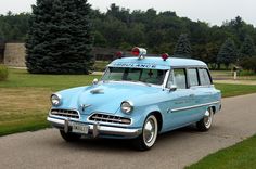 an old police car is parked on the side of the road