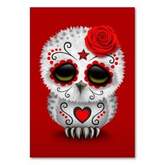 a white owl with red roses on it's head sitting in front of a red background