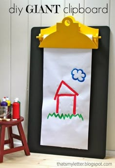 a child's art project is displayed on a white board with the words, diy giant clipboard