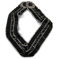 a black and silver necklace with beads on it