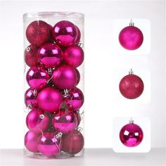 pink ornaments are in a clear container with white tags on the bottom and red ornament balls below