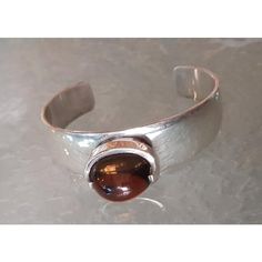 The Weight of this unique Designer Silverwork is 65 gr. Incl. the Stone This piece has an attribution mark,   I am sure that it is completely authentic and  take full responsibility for any authenticity   issues arising from misattribution Modern Brown Jewelry For Anniversary, Silver Gemstone Cuff Bracelet For Formal Occasions, Elegant Brown Cuff Bracelet As Gift, Unique Cuff Bangle For Formal Occasions, Modern Handmade Bracelets For Anniversary, Formal Silver Cuff Bracelet With Gemstone, Brown Cuff Bracelets For Formal Occasions, Oval Gemstone Bangle For Formal Events, Modern Handmade Cuff Bracelet For Formal Occasions