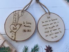 two personalized wooden christmas ornaments hanging from twine