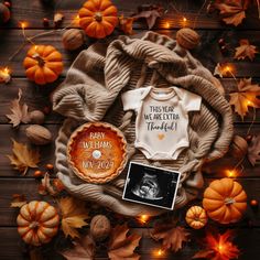 a baby's first thanksgiving outfit and other items on a table