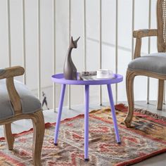 two chairs and a table with a cat figurine on it