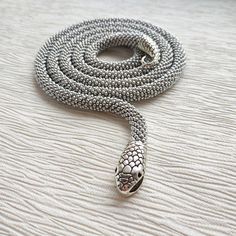 A handmade silver snake necklace from high-quality seed beads, cotton yarn with a snake head and tail clasps (jewelry hypoallergenic aluminum) is very flexible and comfortable to wear. * MEASUREMENTS: Necklace Length on photo: 40 inches (100 cm). Custom length available! Custom colors available! * This snake necklace could be lovely accessorize for your look every day, or special evening. This beaded necklace also is a perfect accessory, which can be worn formally or casually to add style to you Handmade Silver Snake Shape Necklace, Handmade Silver Snake Necklace, Handmade Silver Snake-shaped Jewelry, Handmade Silver Snake Jewelry, Silver Snake Necklace, Serpent Necklace, Snake Necklace Silver, Gothic Bracelet, Silver Statement Necklace