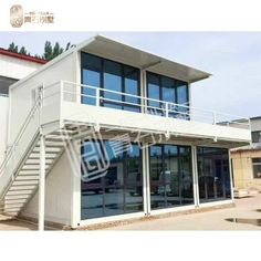 an image of a building with stairs leading up to the top floor and glass doors