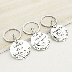 three personalized key chains with names on them