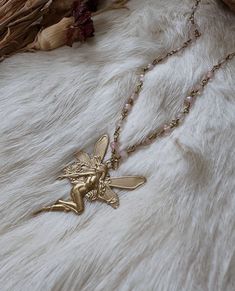 These gorgeous ethereal necklaces are made out of real rose quartz beads and brass chain. The fairy charm is vintage brass. These necklaces make a beautiful complement to any occasion and outfit 🦋 ️  Unleash your inner ethereal fairy 🌙 Necklace length I'm wearing is 19 inches Fairies and nymphs are a bit different in comparison but also very alike. Nymphs are usually human sized and extremely beautiful and ethereal beings. Fairies and pixies are tiny human like creatures who are usually little Fairy Pendant Necklace, Fairycore Beaded Jewelry For Festivals, Fairycore Beaded Festival Jewelry, Festival Fairycore Beaded Jewelry, Gold Fairycore Jewelry Gift, Ethereal Handmade Gold Necklaces, Handmade Gold Crystal Necklace With Rose Quartz, Bohemian Rose Quartz Beaded Necklace, Bohemian Gold Rose Quartz Jewelry