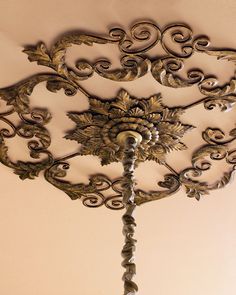 an ornate light fixture hanging from the ceiling