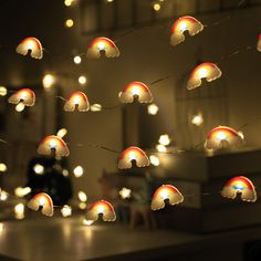 a string of white lights with red and yellow umbrellas hanging from it's sides