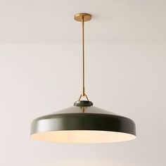 a light fixture hanging from the ceiling in a room with white walls and flooring