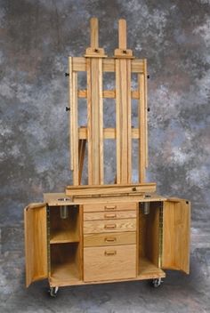 an artist's easel on wheels with drawers