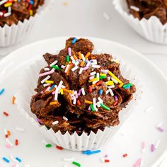 chocolate cupcakes with sprinkles on a white plate