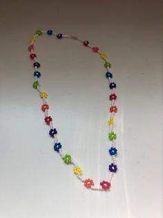 "Daisy Chain Necklaces/Flower Necklaces with multiple colour options available. If there is a pattern or colour palette you would like and do not see here, please do not hesitate to message! These daisy chain necklaces are the perfect accessory to add colour and class to any outfit. The necklaces are dainty and simple, but add a lovely pop of colour. Each necklace has a coordinating barrel clasp. With Spring and Summer around the corner, it is the perfect time to accessorize with a pretty daisy Trendy Multicolor Flower Necklace With Colorful Beads, Trendy Handmade Multicolor Flower Necklace, Trendy Multicolor Beaded Flower Necklace, Multicolor Beaded Necklaces With Flower Charm, Trendy Multicolor Necklace With Flower Charm, Multicolor Flower Necklace With Beaded Chain, Multicolor Flower Pendant Necklace With Colorful Beads, Multicolor Beaded Chain Flower Necklace, Multicolor Adjustable Beaded Necklace With Flower Pendant