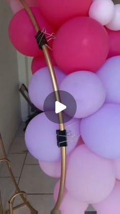 a bunch of balloons that are next to each other in the air with a hose attached to them