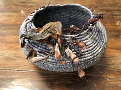 a basket filled with dead bugs on top of a wooden table