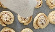 a pan filled with pastries covered in powdered sugar