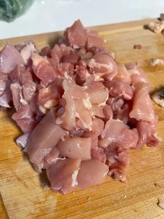 chopped meat sitting on top of a wooden cutting board