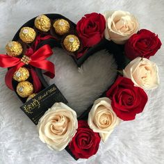 a heart shaped wreath with roses and chocolates