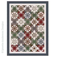 a quilted wall hanging on the side of a white wall with red, green and blue stars