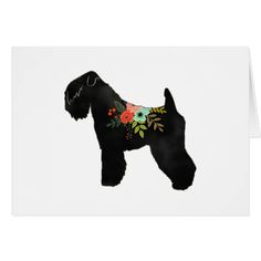 a black dog with flowers on it's collar is standing in front of a white background