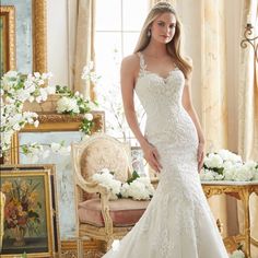 a woman in a wedding dress posing for the camera