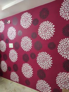 a red wall with black and white flowers on it