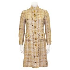 An incredible Chanel Haute Couture coat from the 1960s. This piece is made from lightweight beige and white woven wool tweed and is embellished with warm gold tone metal round buttons with a woven motif. The jacket features a standing collar and two functional patch slit top pockets with faux flaps. Beautiful cream silk lining. As with all Chanel Haute Couture pieces, there are many seams throughout so that this piece can be expertly tailored to be larger or smaller. Haute Couture label with code (bolduc) # 42 271 hand written on back. Handmade in France. This piece has been dry cleaned and is in excellent vintage condition - there is some light staining on the interior of the left wrist, but cannot be seen when wearing. Fits like a US size 4. Shoulder 14” Sleeve 22.5” Bust 34” Waist 31” H 1960s Chanel, Haute Couture Coat, Chanel Couture, Chanel Haute Couture, Standing Collar, Cream Silk, Chanel Vintage, Vintage Chanel, Anne Klein