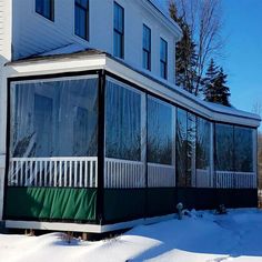 a large white house sitting on top of snow covered ground