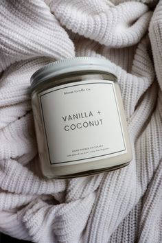 vanilla and coconut candle on white blanket