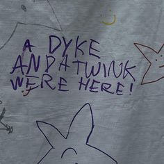 a sign that says, a dyke and a twnk were here