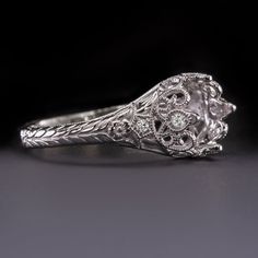 an antique style diamond ring with filigrees