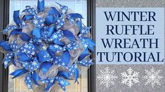 a blue and silver wreath sitting in front of a door with snowflakes on it