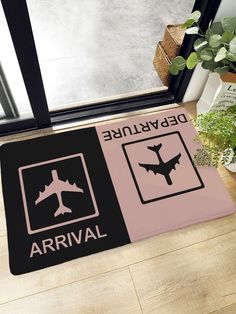 a door mat that has an airplane and warning sign on it, next to a potted plant