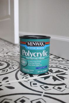 a can of polycrylic sitting on top of a black and white floor