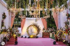 an outdoor ceremony with chandeliers and decorations