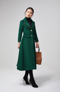 "This stunning dark green wool coat for womens is beautifully fitted and tailored for a classic, feminine design. There is a brooch decoration on lapels.The long wool coat features dark green, a slim fitting bodice with long sleeves and fitted waist leading into a long,flowing skirt coat. Details : * dark green wool blend fabric with polyester lining * two pockets * button closure in front * lapel collar * long sleeves * brooch decoration * winter coat, spring coat, womens coat * mid calf length Green Wool Coat For Work, Dark Green Outerwear For Winter Workwear, Elegant Green Wool Coat, Elegant Green Wool Coat For Winter, Elegant Green Wool Coat For Fall, Green Wool Coat For Workwear, Green Wool Workwear Coat, Green Long Sleeve Wool Coat For Work, Skirt Coat