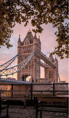 the tower bridge is very tall and has a clock on it's side,