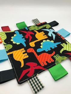 several colorful ties laid out on top of each other in the shape of an animal