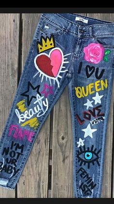 a pair of jeans with graffiti written on the side and hearts, flowers, and stars