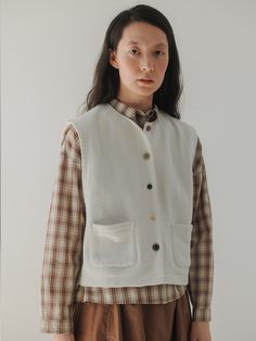 Editor's NotesThis is the 'tig button vest' from Monochrome, a piece that beautifully encapsulates a vintage autumn mood. This vest features a regular fit and a basic silhouette, making it ideal for layering.- Made from jersey fabric, providing durability and a strong structure- The use of various sizes and colors of natural buttons made from wood, nuts, and buffalo horn- Reflecting Monochrome's characteristic styleMeasurements(in.)One Size(XS-M)- Shoulder: 15.94 in.- Chest: 19.88 in.- Hem: 19.69 in.- Length: 20.20 in.* Model Info: Height 5' 84 Top Korean 55Composition & Care- 95% Cotton, 5% Polyester- HAND WASH ONLY (Neutral detergent / In cold water) / DO NOT USE DRYERDesigner- by MONOCHROME Casual Button Closure Vest For Fall, Casual Fall Vest With Button Closure, Casual Vest With Button Closure For Fall, Fall Denim Vest With Button Closure, Cotton Vest With Snap Buttons For Work, Classic Fall Vest With Pockets, Casual Button-up Vest For Everyday Wear, Classic Button-up Vest For Fall, Fall Layering Sweater Vest With Button Closure