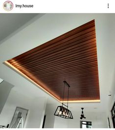 a room with some lights hanging from it's ceiling and wood slats on the ceiling