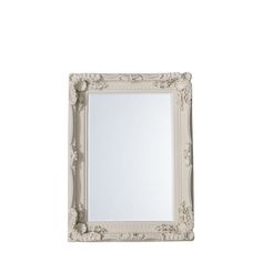 a white framed mirror sitting on top of a wall