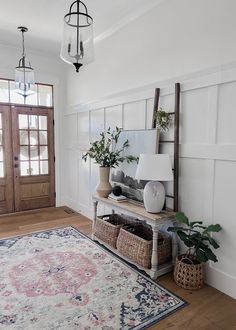 a living room with a rug, lamp and potted plants