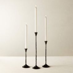 three white candles sitting next to each other