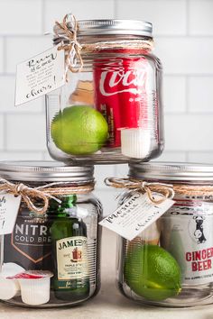 three mason jars with limes, ginger ale, and coca - cola in them