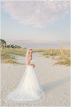 a woman in a wedding dress on the beach