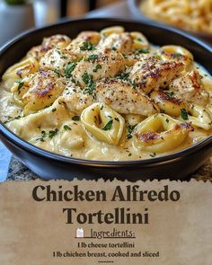 chicken alfredo with tortellini in a black bowl