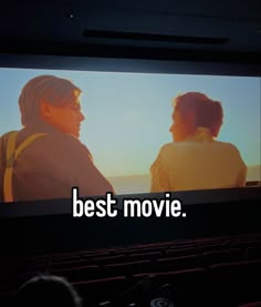 two people sitting in front of a screen with the words best movie on it